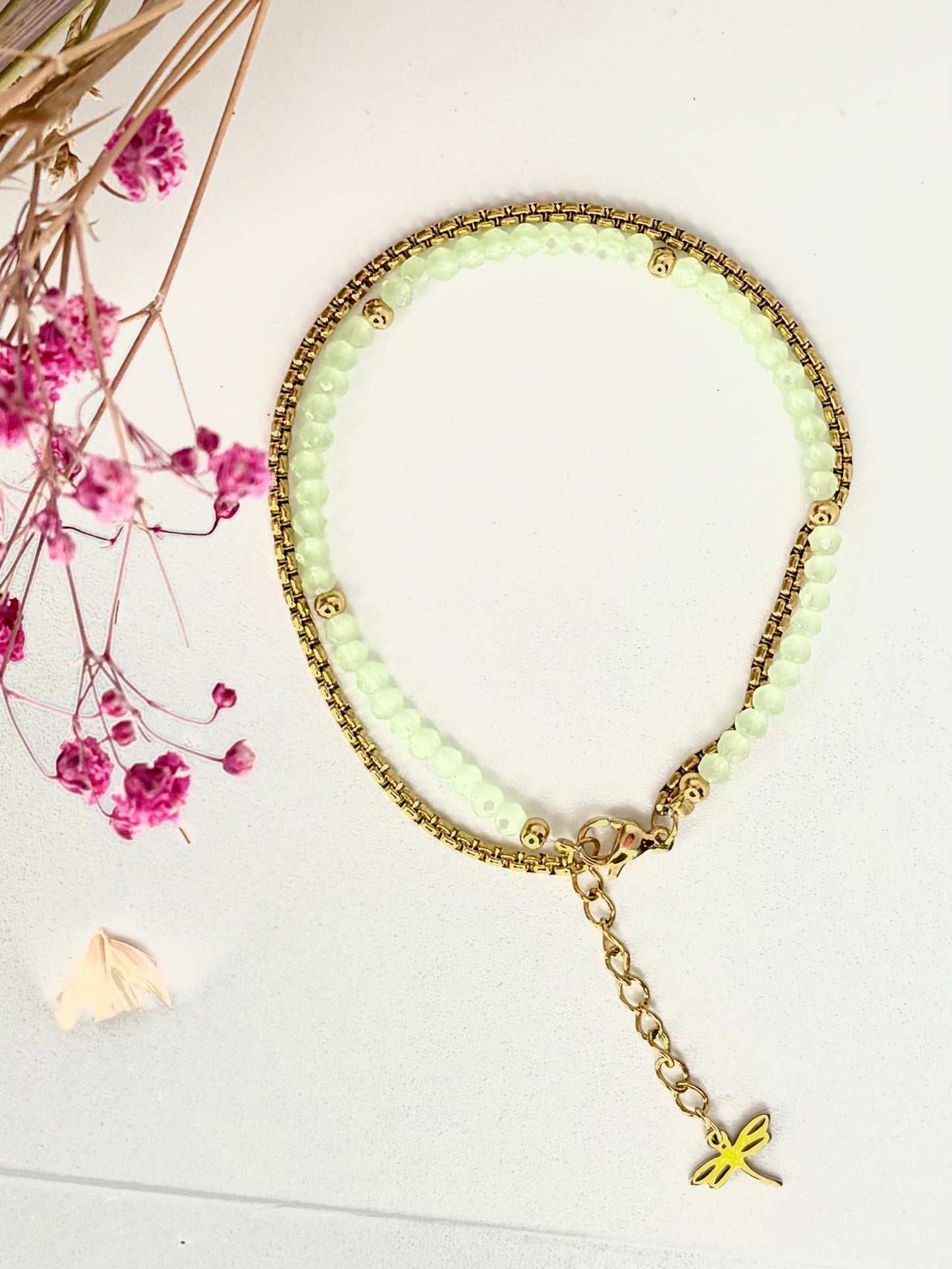 La pulsera Doble Esencia combina acero y cristal en un diseño ajustable con colgante. Hecha a mano, disponible en varios colores.